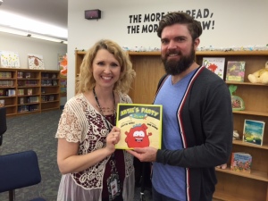 Librarian, Mary Ann Riley, and Justin Noble holding the book "Artie's Party".